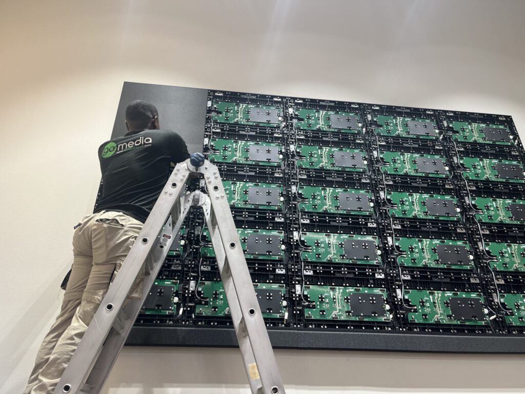 Go Media technician servicing modular Direct View LED display panels