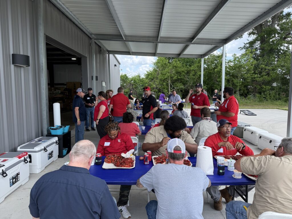 Customer appreciation crawfish boil with clients enjoying food and conversation